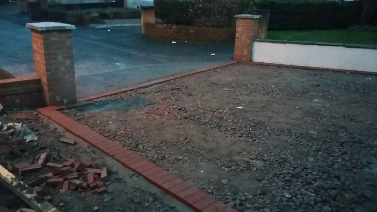 Finished block-paved courtyard beside a brick home